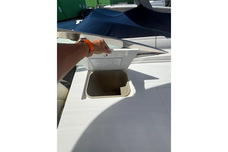 Slide: The Image of 2022 Regal 33 OBX boat storage compartment with open lid, showcasing interior space. - 40