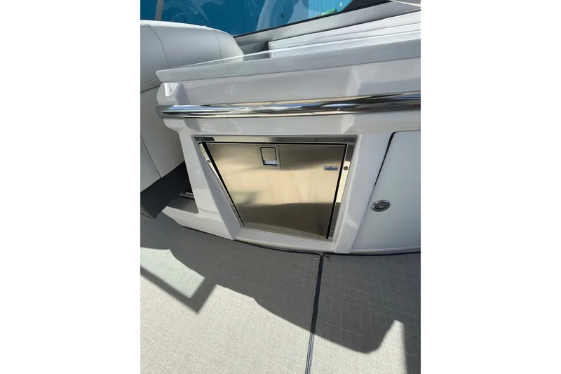 Slide: The Image of 2022 Regal 33 OBX boat interior with stainless steel appliance and sleek design. - 14