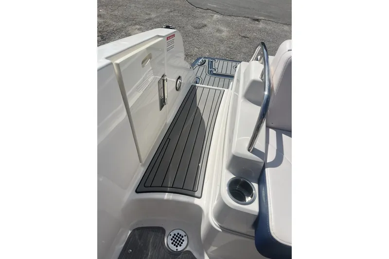 Slide: The Image of 2020 Chaparral 297 SSX boat interior with sleek seating and stainless steel cup holder. - 12