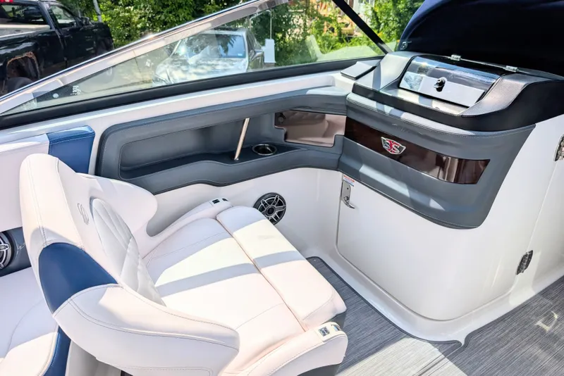 Slide: The Image of 2020 Chaparral 297 SSX boat interior with luxurious seating and modern dashboard design. - 7