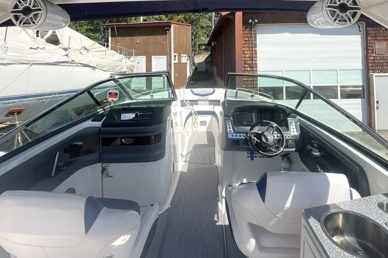 Slide: The Image of 2020 Chaparral 297 SSX boat interior with modern dashboard and seating. - 2