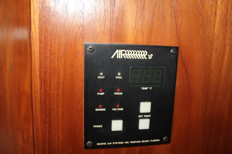 Slide: The Image of Control panel on 1989 Californian 55 Cockpit Motor Yacht, featuring temperature and system indicators. - 35
