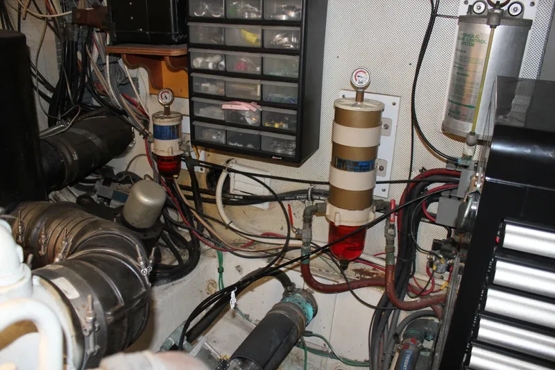 Slide: The Image of Engine room of 1989 Californian 55 Cockpit Motor Yacht with mechanical components and wiring. - 25