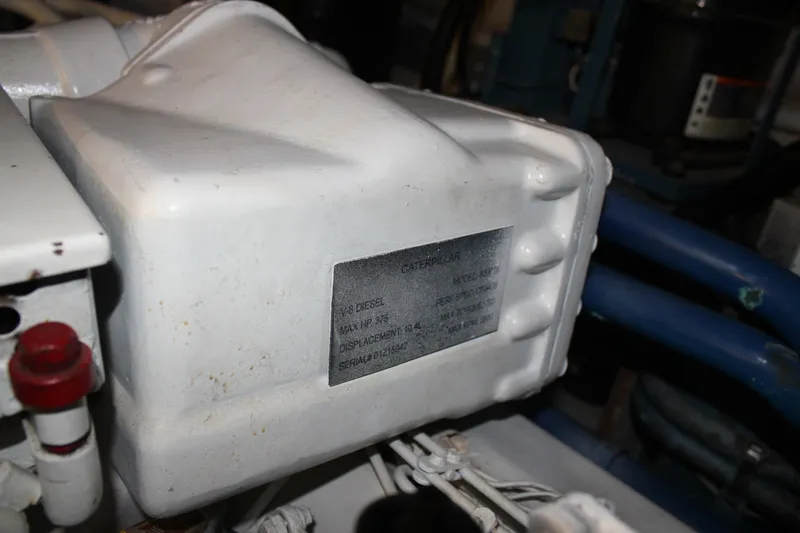 Slide: The Image of Engine compartment of 1989 Californian 55 Cockpit Motor Yacht, featuring Caterpillar V-8 diesel engine. - 27