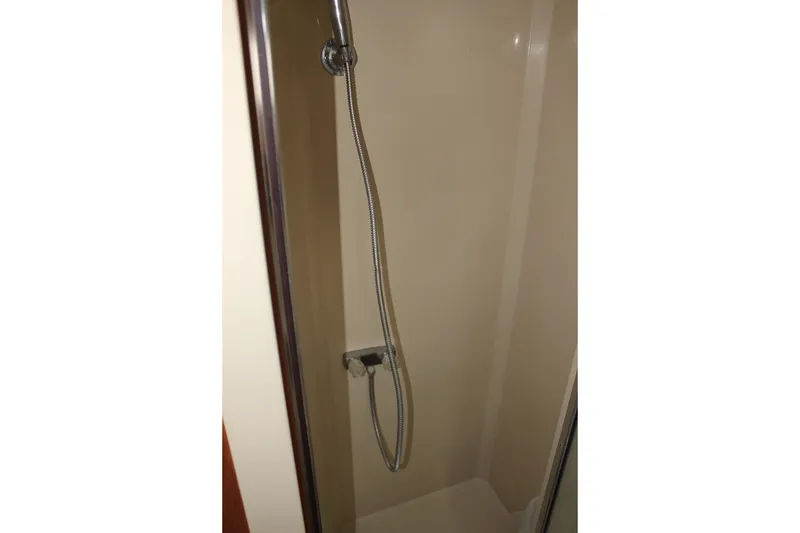 Slide: The Image of Shower area in 1989 Californian 55 Cockpit Motor Yacht, featuring a handheld showerhead. - 33