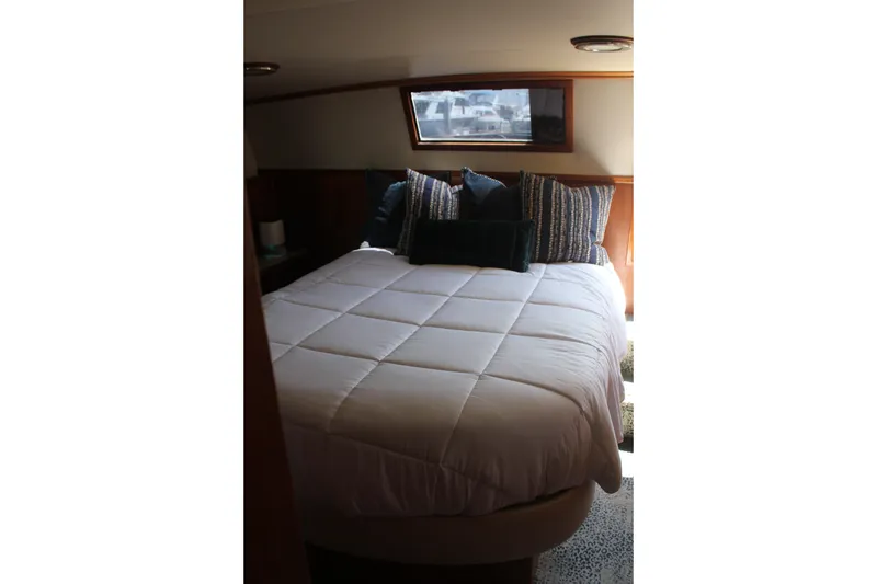 Slide: The Image of Luxurious bedroom interior of 1989 Californian 55 Cockpit Motor Yacht with cozy bedding. - 28