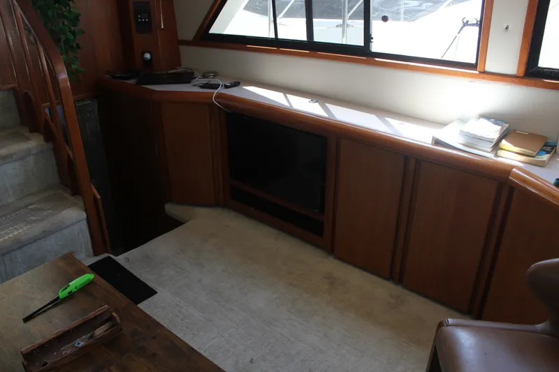 Slide: The Image of Interior of 1989 Californian 55 Cockpit Motor Yacht with wooden cabinetry and stairs. - 14
