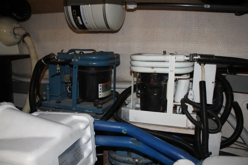 Slide: The Image of Engine room of 1989 Californian 55 Cockpit Motor Yacht with mechanical equipment and piping. - 22