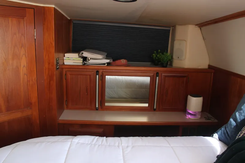 Slide: The Image of Cozy cabin interior of 1989 Californian 55 Cockpit Motor Yacht with wooden cabinetry. - 36