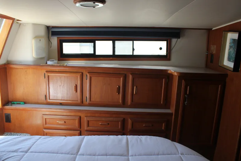 Slide: The Image of Interior of 1989 Californian 55 Cockpit Motor Yacht with wooden cabinetry and window. - 34