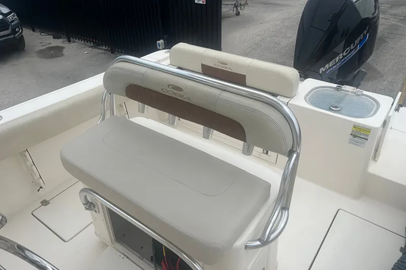 Slide: The Image of 2023 Cobia 237 Center Console boat interior with seating and Mercury engine. - 6