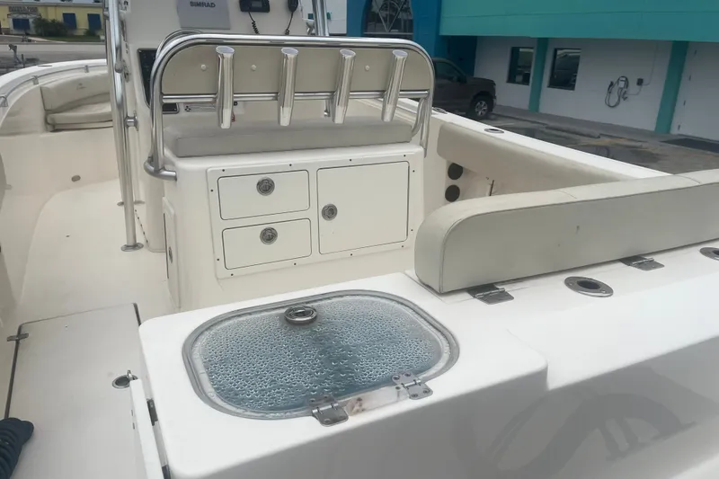 Slide: The Image of 2023 Cobia 237 Center Console boat interior with seating and storage compartments. - 11