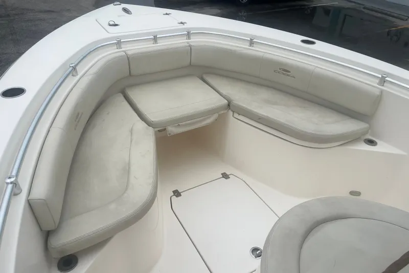 Slide: The Image of 2023 Cobia 237 Center Console boat interior with cushioned seating and storage compartments. - 9