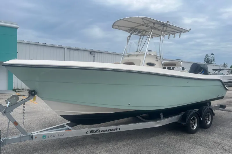 Slide: The Image of 2023 Cobia 237 Center Console boat on trailer, parked outdoors. - 3