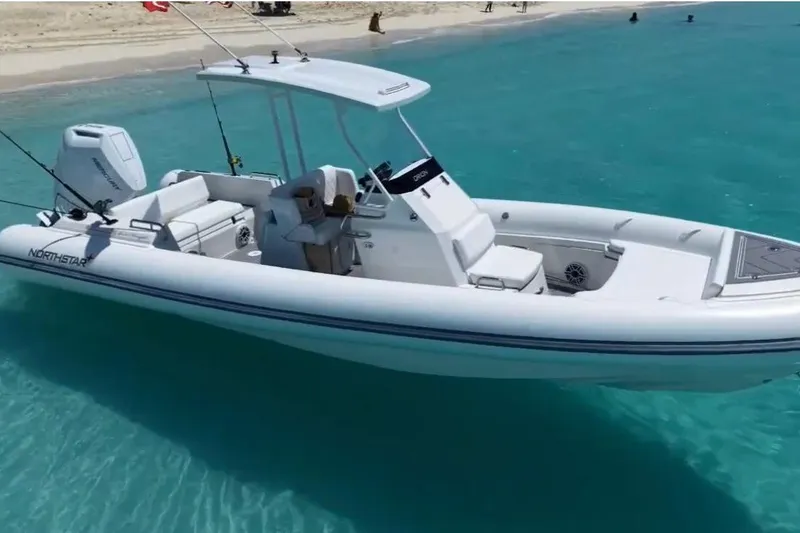 The Image of 2023 Northstar Orion 8 boat on clear turquoise water near sandy beach. - 1