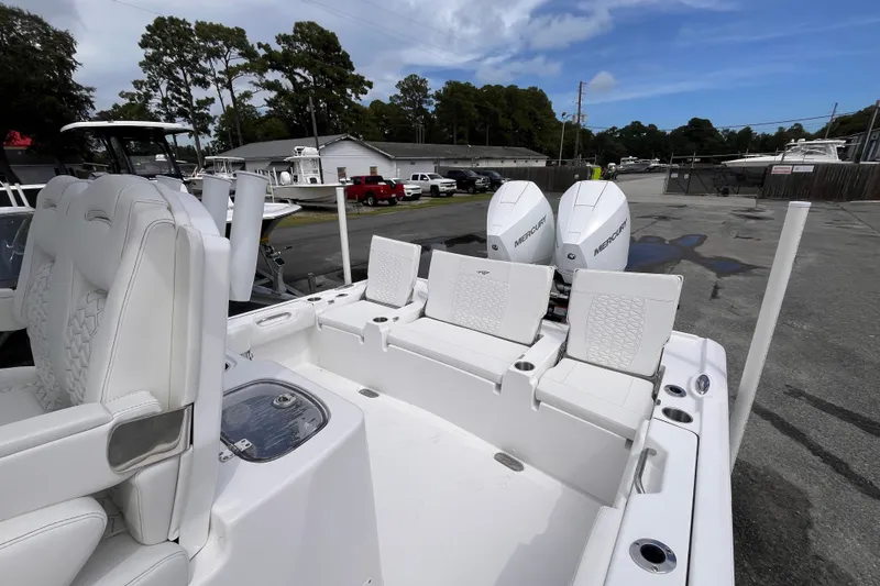 Slide: The Image of 2027 Tidewater 2700 Carolina Bay boat with dual Mercury engines, white seating, and spacious deck. - 16