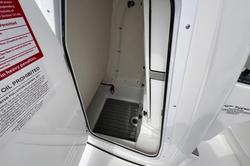 Slide: The Image of Interior view of 2027 Tidewater 2700 Carolina Bay boat compartment with safety instructions. - 14