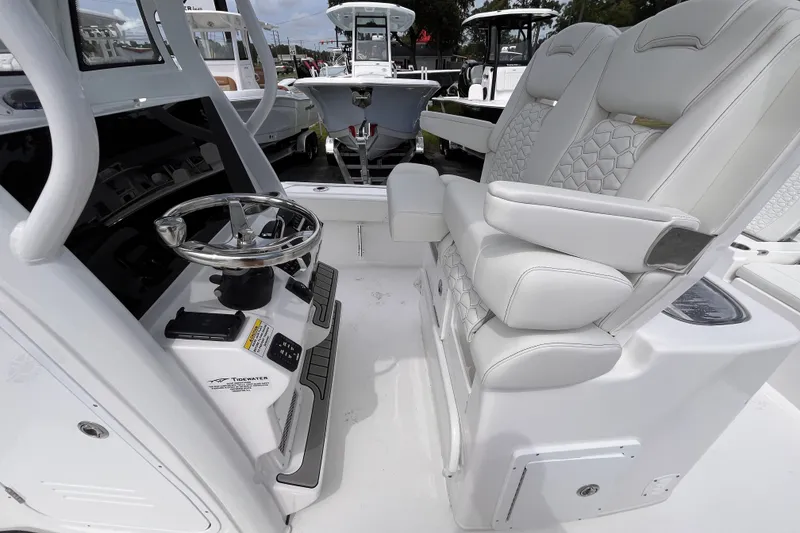 Slide: The Image of 2027 Tidewater 2700 Carolina Bay boat interior with modern helm and plush seating. - 15