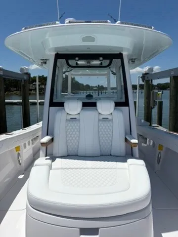 Slide: The Image of 2026 Phenom 34 with luxurious white seating and modern design, docked by the water. - 16