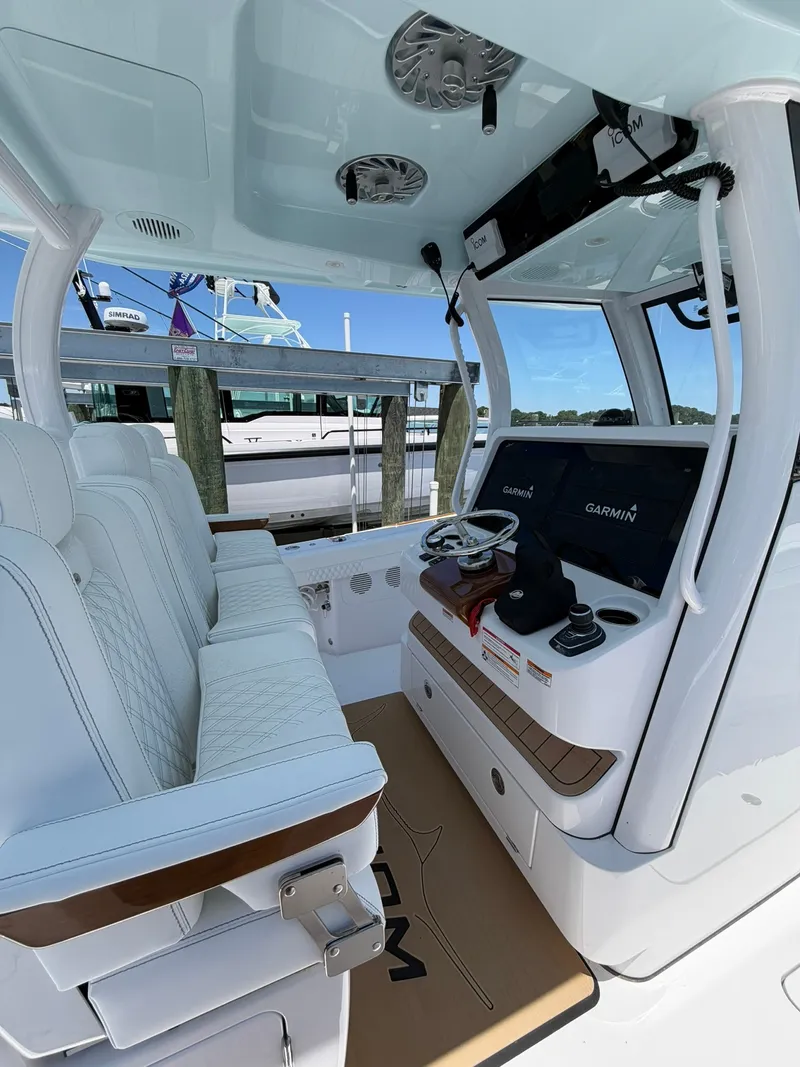 Slide: The Image of The image shows the cockpit of a 2026 Phenom 34 boat with modern navigation systems. - 22