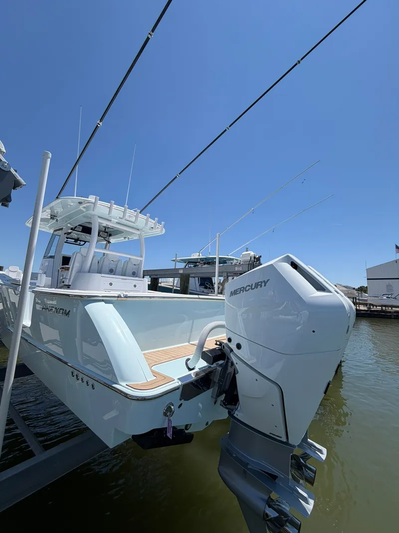 Slide: The Image of The image shows a modern boat docked. It features a Mercury outboard motor. - 24