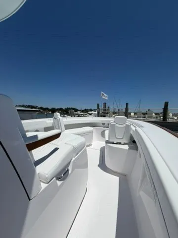 Slide: The Image of The image shows the deck of a 2026 Phenom 34 boat with white seating and a clear sky. - 25