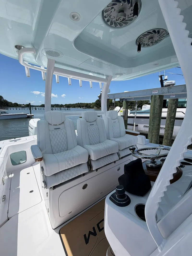 Slide: The Image of The image shows the cockpit of a Phenom 34 boat with luxurious white seats and a modern helm. - 11