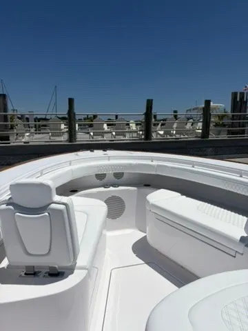 Slide: The Image of The image shows the cockpit of a Phenom 34 boat at a dock. White seating and sleek lines dominate the design. - 13