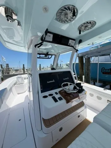 Slide: The Image of 2026 Phenom 34 with a modern helm and sleek seating at the dock. - 20