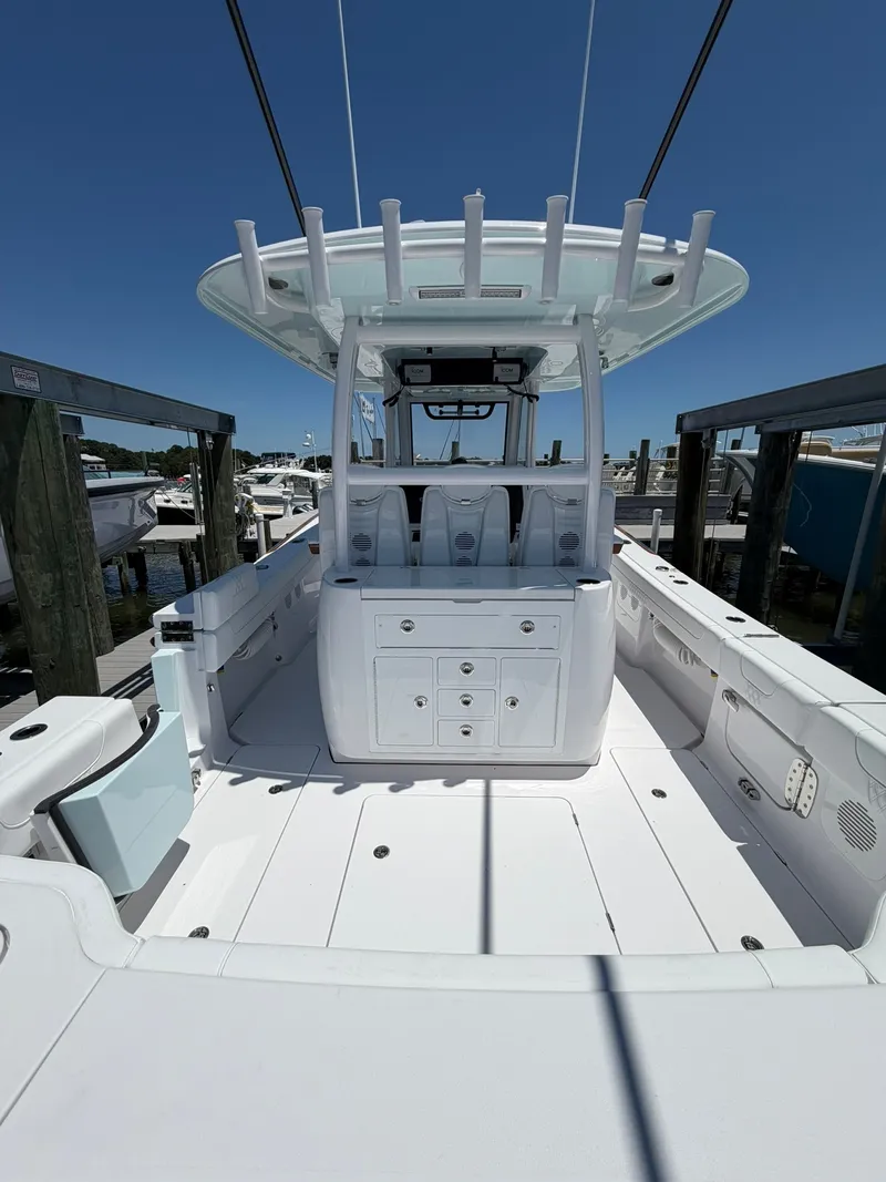 Slide: The Image of The image shows a modern boat, the 2026 Phenom 34 model, featuring a spacious, white deck. - 15