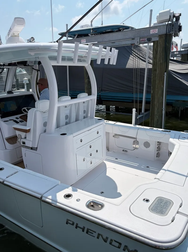Slide: The Image of The image shows a modern boat, the Phenom 34, year 2026, with a spacious deck and sleek white surfaces. - 23
