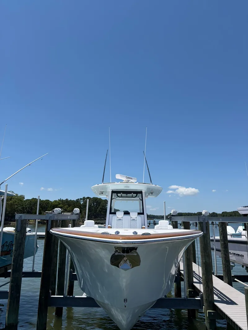 Slide: The Image of 2026 Phenom 34 at a dock, with a clear sky in the background. - 9