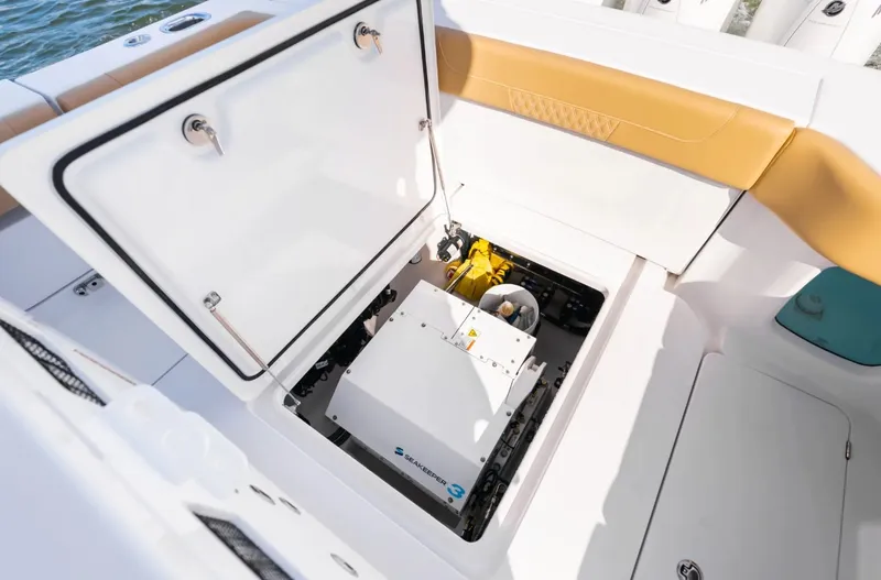 Slide: The Image of An open compartment on a boat reveals a generator and yellow cables. - 30