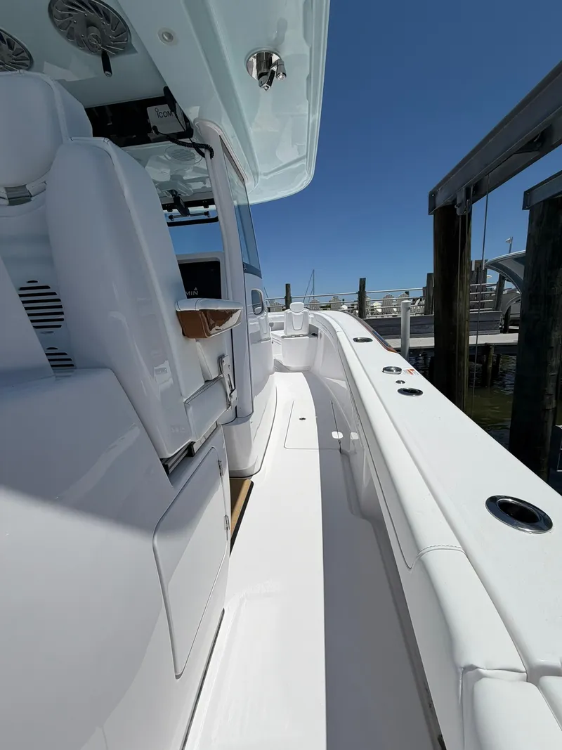 Slide: The Image of The image shows the deck of a 2026 Phenom 34 boat with white seating and a clear blue sky. - 17