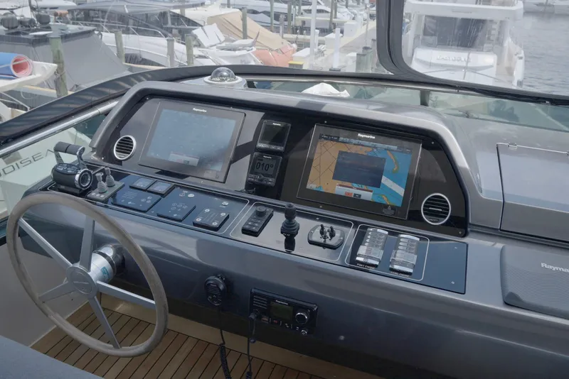 Slide: The Image of Control panel of a 2018 Sanlorenzo SL78 yacht with navigation screens and steering wheel. - 42