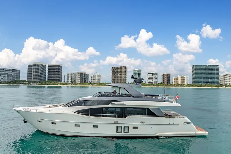 Slide: The Image of 2018 Sanlorenzo SL78 yacht on calm water with city skyline backdrop. - 1