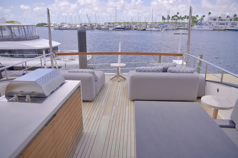 Slide: The Image of Luxurious 2018 Sanlorenzo SL78 yacht deck with seating and grill, overlooking marina. - 46