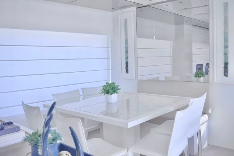 Slide: The Image of Interior of the 2018 Sanlorenzo SL78 featuring a modern white dining area with sleek chairs. - 8