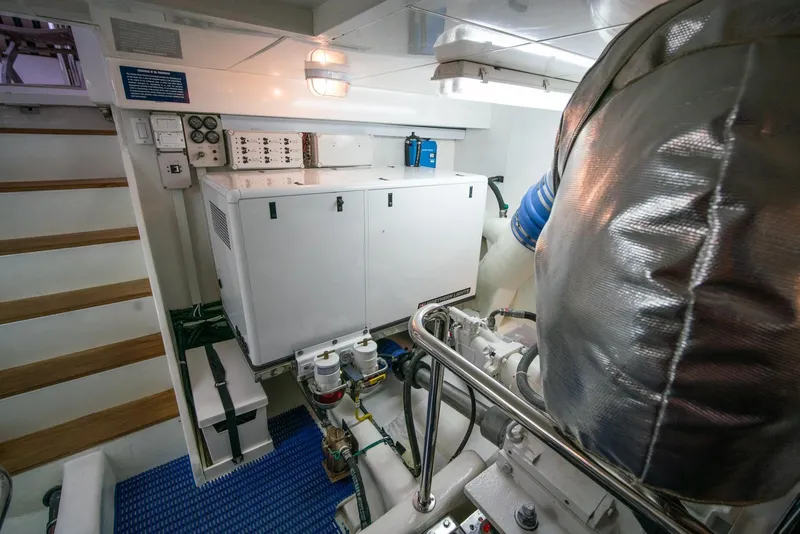 Slide: The Image of The engine room of a 2013 Ocean Alexander 65 Pilothouse with engines and control systems. - 53