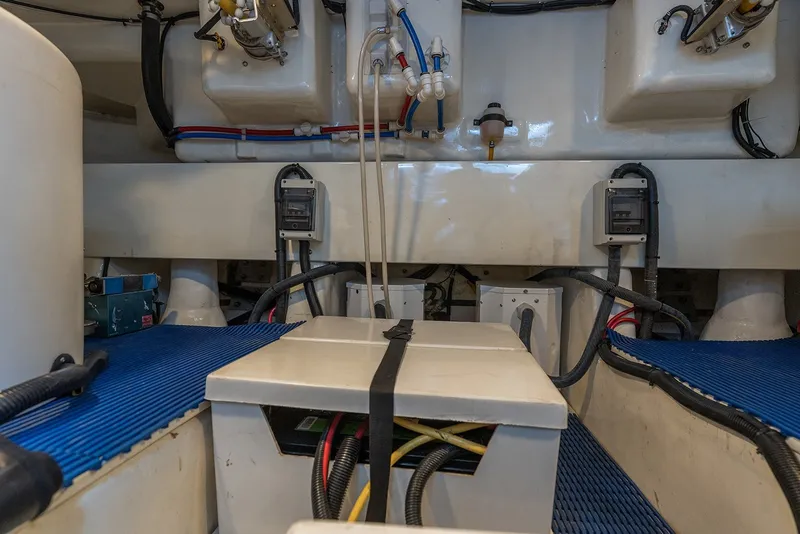 Slide: The Image of Engine room of 2013 Ocean Alexander 65 Pilothouse yacht, showcasing mechanical components and wiring. - 47