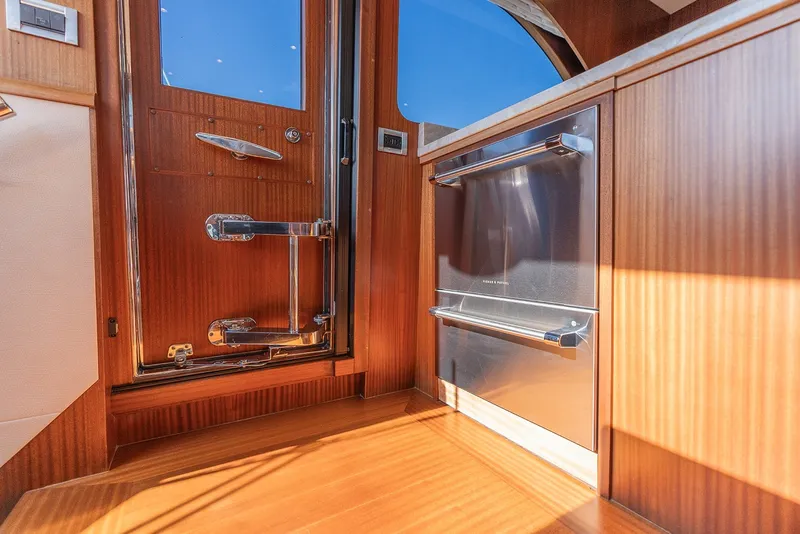 Slide: The Image of Luxurious interior of 2013 Ocean Alexander 65 Pilothouse yacht with wood finish and stainless steel accents. - 16