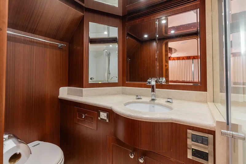 Slide: The Image of Luxurious bathroom in 2013 Ocean Alexander 65 Pilothouse yacht with wood accents and modern fixtures. - 31