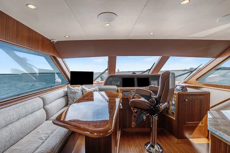 Slide: The Image of Pilothouse interior of 2013 Ocean Alexander 65, featuring luxurious seating and panoramic windows. - 2