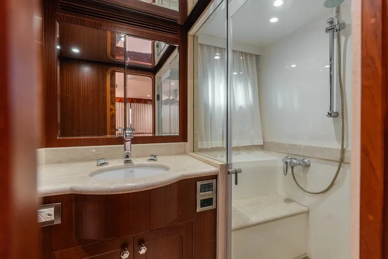 Slide: The Image of Luxurious bathroom in 2013 Ocean Alexander 65 Pilothouse yacht, featuring elegant wood and marble finishes. - 32