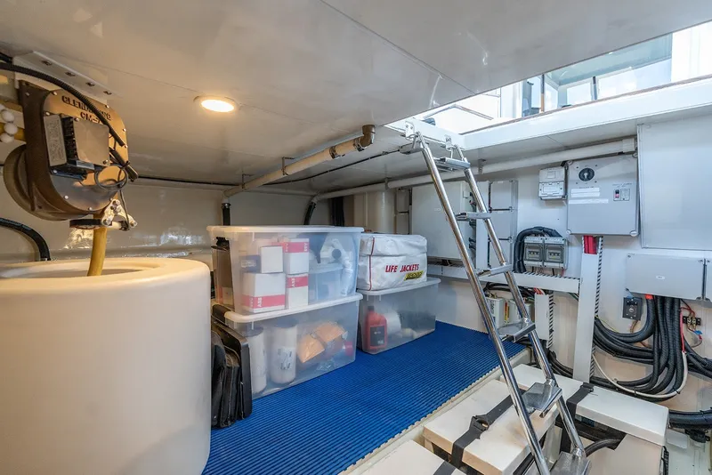 Slide: The Image of Storage area in 2013 Ocean Alexander 65 Pilothouse with ladder, life jackets, and equipment. - 43