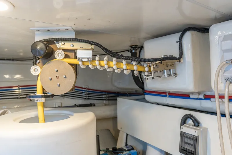 Slide: The Image of Engine room of 2013 Ocean Alexander 65 Pilothouse yacht, showcasing mechanical components and wiring. - 46