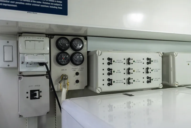 Slide: The Image of Control panel of a 2013 Ocean Alexander 65 Pilothouse yacht, featuring gauges and switches. - 48