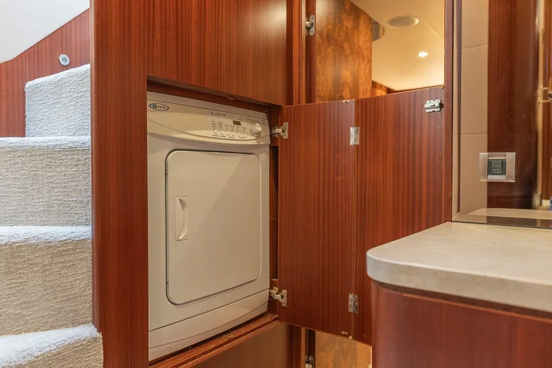 Slide: The Image of Laundry area with dryer in 2013 Ocean Alexander 65 Pilothouse yacht interior. - 25