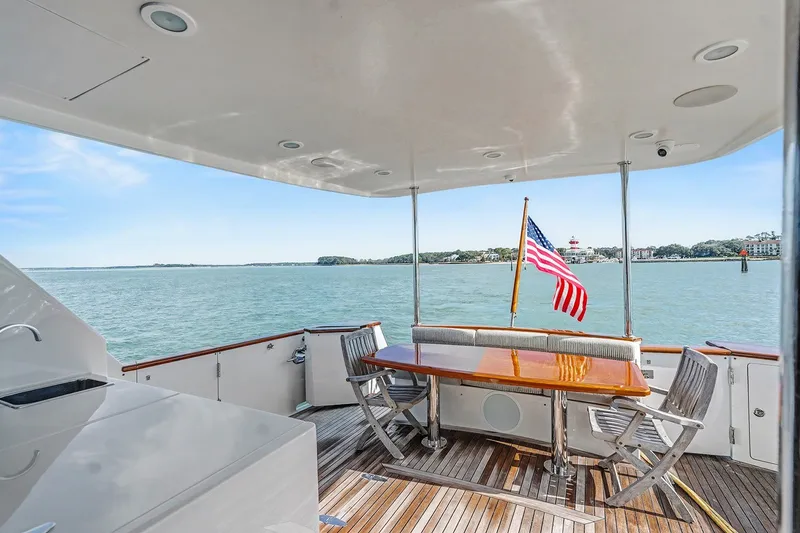 Slide: The Image of Aft deck of 2013 Ocean Alexander 65 Pilothouse yacht with American flag and ocean view. - 6
