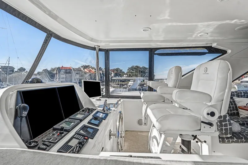 Slide: The Image of Pilothouse interior of 2013 Ocean Alexander 65, featuring modern navigation equipment and luxurious seating. - 39